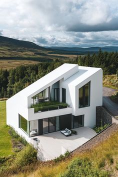 an aerial view of a modern house in the countryside