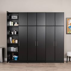 a room with black cabinets and white chairs