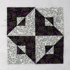 the block is made up of black and white fabric with swirly designs on it