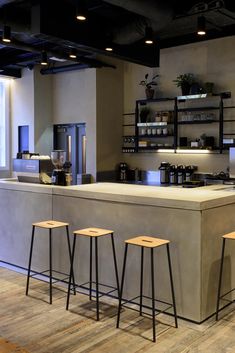 an industrial style kitchen with bar stools