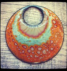 an orange and green circular object sitting on top of a wooden table