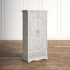 a white cabinet sitting on top of a wooden floor