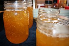 three jars filled with liquid sitting on top of a table