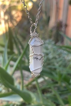 "Beautiful wire wrapped White Howlite crystal point pendant on matching chain with lobster claw closure. The wire used in the pictures is light silver color, but other options are available. The pendant is approximately 1.25\" long and 0.4\" wide. Please note that all crystals are unique and therefore color, shape and size may vary slightly. Please choose a necklace length from the drop-down menu. In case you would like a length other than the listed options, leave us a note at checkout. Item wi Howlite Crystal, Titanium Quartz, Boho Crystal, White Howlite, Necklace Boho, Crystal Gifts, Crystal Points, Healing Crystals, Jewelry Pouch