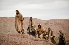 the men are walking up a hill together