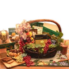 a basket filled with lots of different types of food and wine on top of a table