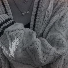 black and white photograph of woman wearing sweater with name tag on it's chest