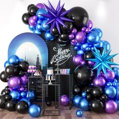 an arch made out of balloons and stars is displayed in front of a backdrop for a birthday party