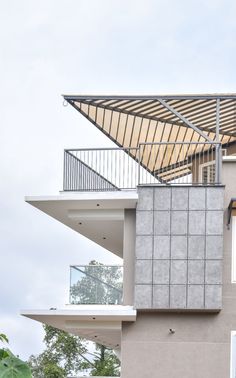 a building with a metal roof and balcony