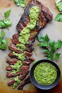 grilled steak with guacamole and parsley garnish on the side