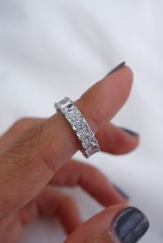 a woman's hand with a diamond ring on it