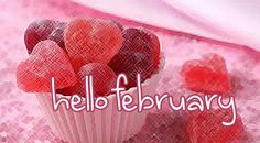 there is a cupcake with hearts on it and the words hello february above it