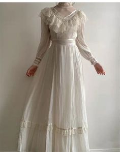 This beautiful Gunne Sax Inspired Victorian Modest Wedding Dress is perfect for the traditional bride who wants to add a touch of vintage style to her wedding. The gorgeous white prom dress is made from a high quality lace fabric that is sure to turn heads. The dress features intricate Victorian details such as the full length sleeves and scalloped neckline. The dress is designed to be modest and comfortable, yet still stylish and elegant. The delicate lace fabric and the flattering fit make thi Lace Victorian Dress, Gunne Sax Wedding Dress, Victorian Lace Dress, Prom Dress Vintage, Modest Wedding Dress, White Prom, Old Fashion Dresses, White Prom Dress, Prom Dresses Modest