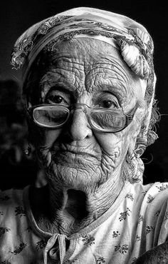 an old woman with glasses and a hat