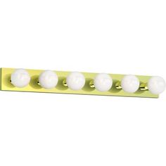 four white balls are mounted on a yellow light fixture, which is attached to the wall