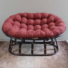 a chair that is sitting on some kind of metal frame with a red seat cushion