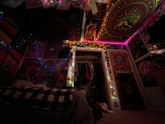 the room is decorated with colorful lights and pictures on the walls, along with other decorations