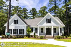 a white house surrounded by trees and grass