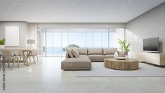 a modern living room with white walls and floor to ceiling windows overlooking the ocean is furnished in neutral tones