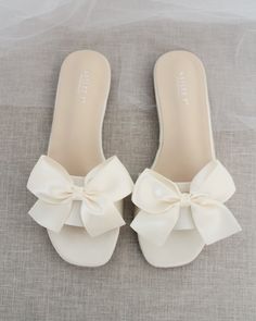 Classic slide flat sandals for casual and dressy look with added SATIN BOW. Simple and easy wear for brides, bridesmaids and wedding parties.DETAILS:COLORS AVAILABLE: Ivory, Light Blue, White, Pink, and ChampagneUPPER: Synthetic upper and liningMATERIALS: Mandmade outsole STYLE NAME: EVELYN Bridesmaids Sandals, Bridesmaid Sandals, Fancy Sandals, Pretty Sandals, Bridal Sandals, Bow Sandals, Girly Shoes, Slip On Sandals, Wedding Sandals