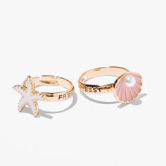 Celebrate your beach bestie with this fun set. These two adjustable rings have "Best" and "Friends" on each side, and one has an enamel starfish, and the other has a faux pearl-embellished seashell. Pack Size: 2 Finish: Gold-tone Fit: Adjustable Material: Metal - Claire's Best Friends Gold Starfish & Seashell Rings (2 Pack) Claires Rings, Preppy Rings, Seashell Rings, Preppy Ring, Preppy Wishlist, Bff Rings, School Wishlist, Dress Reference, Preppy Things