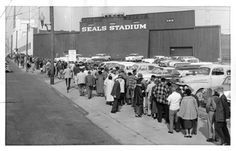 an old black and white photo of people standing in front of a building with seals stadium on it