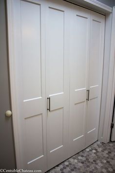 two white closet doors in a room with tile flooring