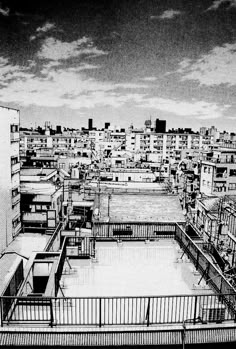 black and white photograph of an urban area with lots of buildings in the foreground