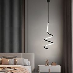 a bedroom with a bed, nightstand and hanging light