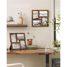 three wooden frames are hanging on the wall above a desk with two vases and other items