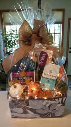 a gift basket filled with wine, snacks and treats for someone's special occasion