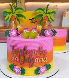 there is a cake decorated with palm trees and flowers