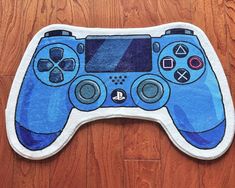 a blue game controller rug sitting on top of a wooden floor