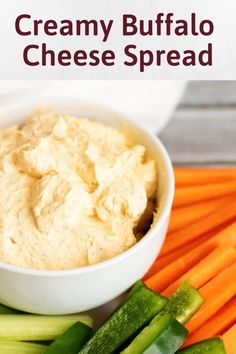 creamy buffalo cheese spread in a white bowl surrounded by carrots and celery