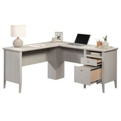 an l shaped desk with drawers and a laptop on it