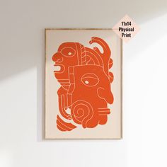 an orange and white art piece hanging on the wall