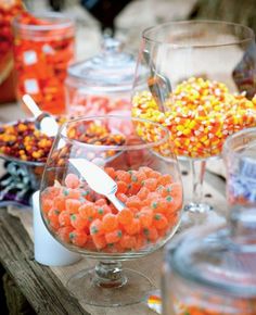 there are many candies in glass bowls on the table