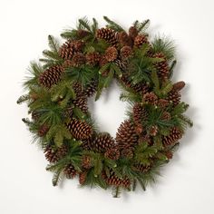 a christmas wreath with pine cones and evergreen needles