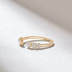 a gold ring with three diamonds on it