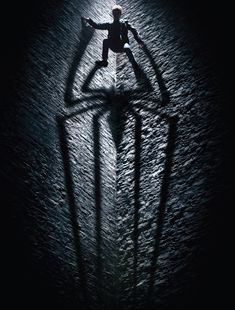 the amazing spider - man movie poster is shown in black and white, with his shadow projected