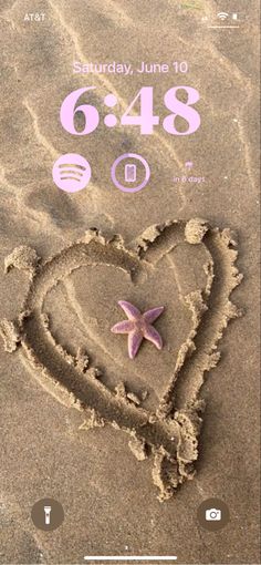 a heart drawn in the sand with a starfish on it's back side