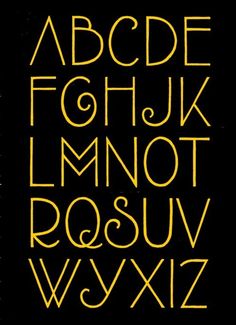 a black and yellow alphabet with gold letters