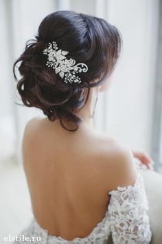 the back of a woman's head wearing a bridal hair comb