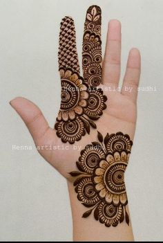 the hand is decorated with henna designs