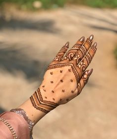 a woman's hand with henna on it