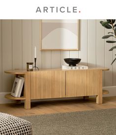 a living room scene with focus on the sideboard and table in the foreground