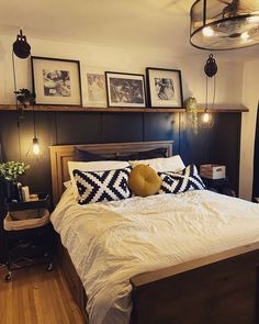 a bedroom with a bed and pictures on the wall