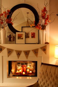 a living room with a fire place and pictures on the mantle, candles in vases