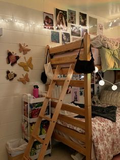 a bunk bed in a dorm room with lots of pictures on the wall and lights hanging from the ceiling