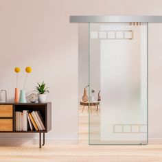 a room with a book shelf and a glass door on the wall next to it